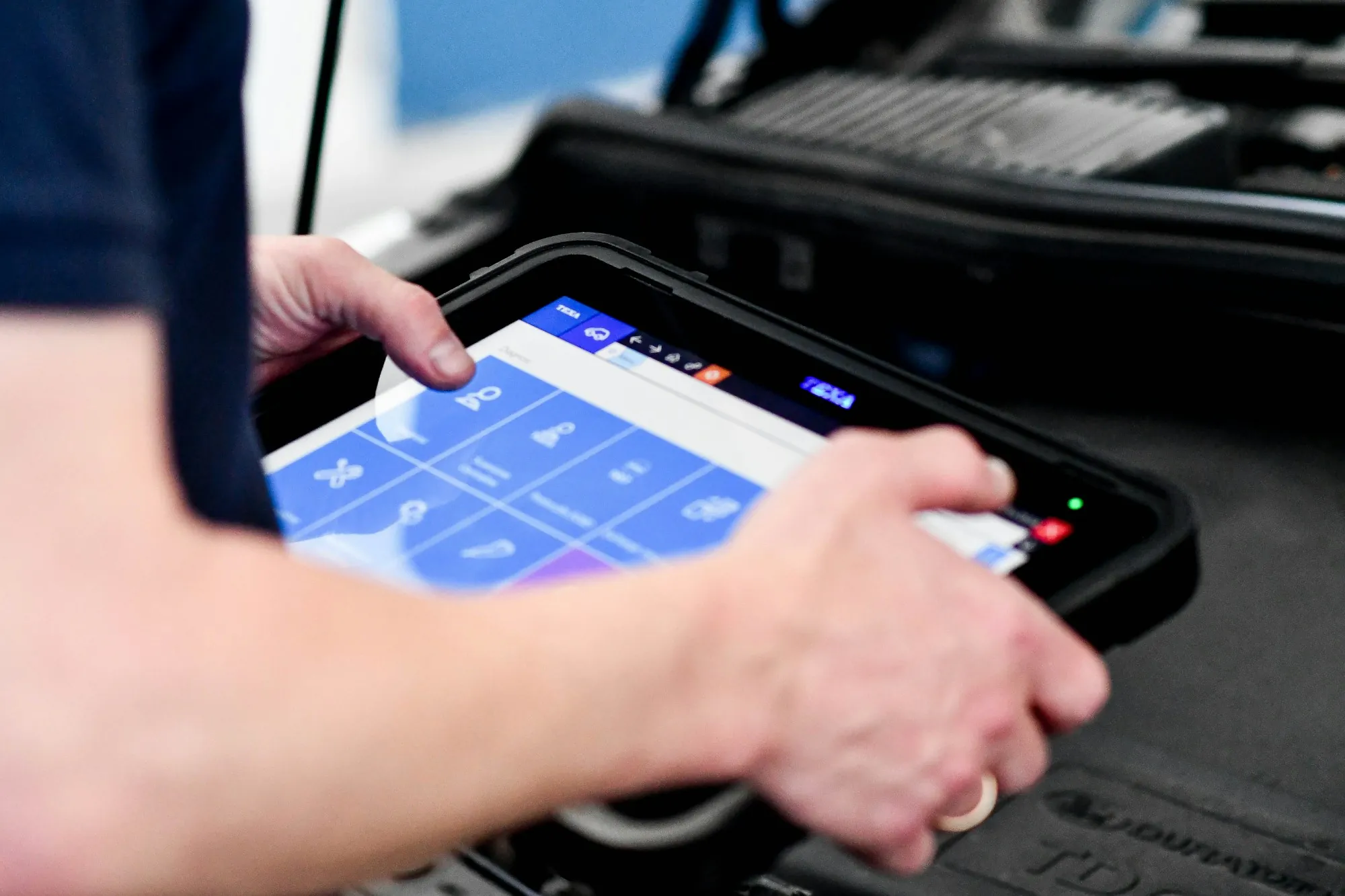 Hand using a diagnostic tablet